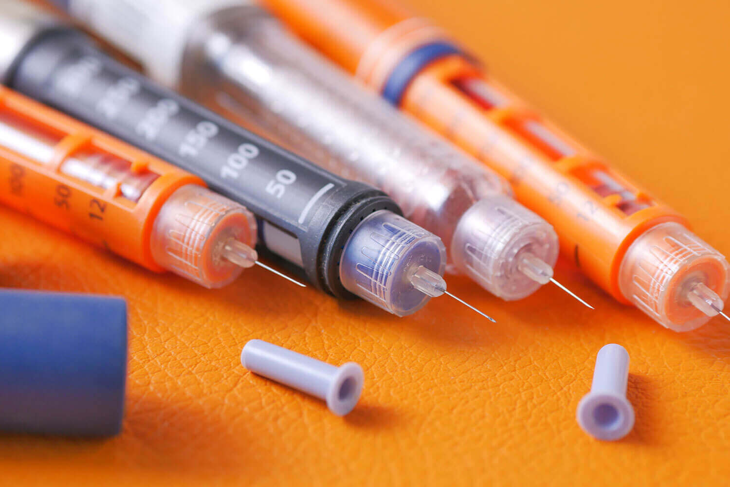 insulin pens on orange background close up 2023 11 27 05 25 18 utc